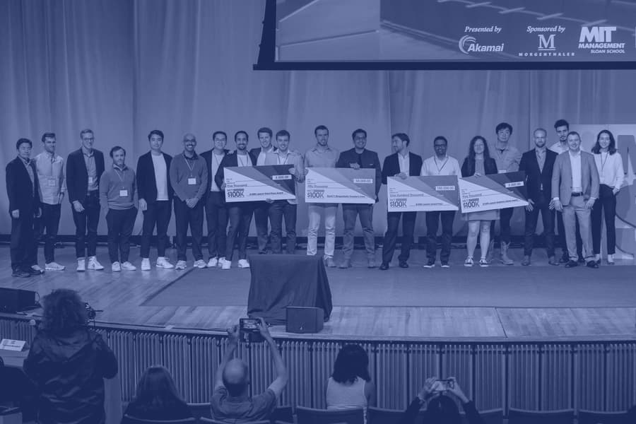 MIT $100K finalists on stage holding their prize checks